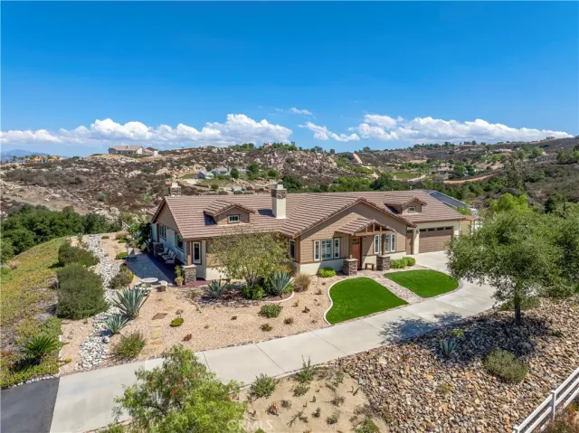 an aerial view of residential houses with outdoor space and ocean view