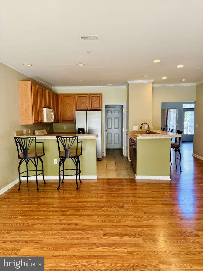629 Ruxton Road, Unit 74 Solomons, MD 20629 - Photo 3 of 24 a living room with furniture and a wooden floor