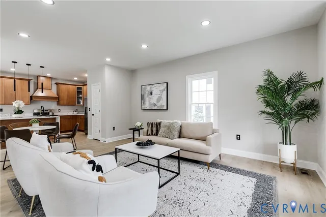 a living room with furniture and a potted plant