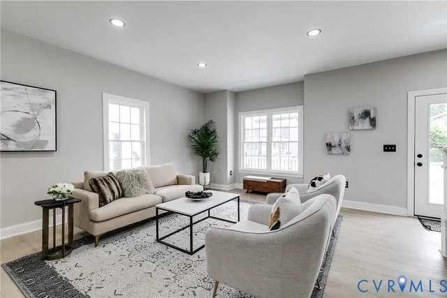a living room with furniture and a large window