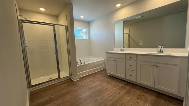 a bathroom with a double vanity sink a mirror and a shower