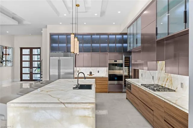 a kitchen with a stove a refrigerator and cabinets