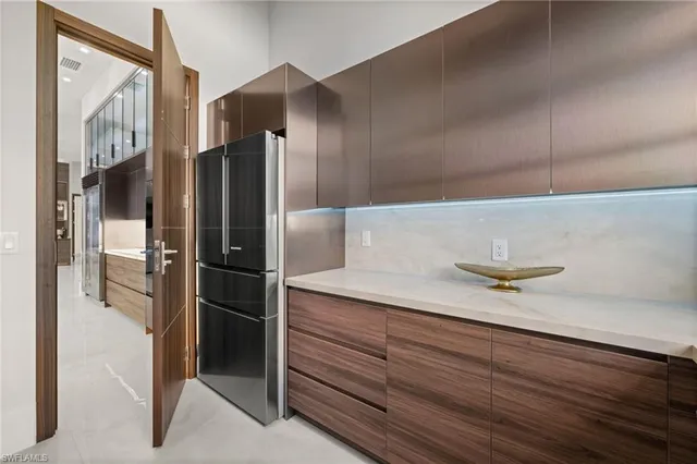 a kitchen with a refrigerator and a sink
