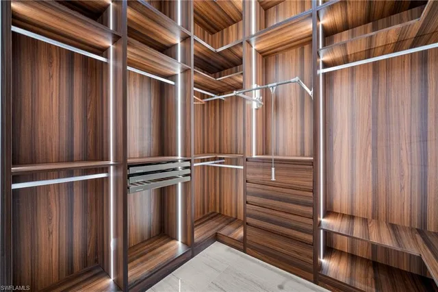 a view of walk in closet with empty racks