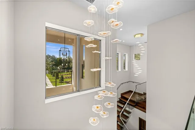 a kitchen with stainless steel appliances a sink a stove top oven a dining table and chairs