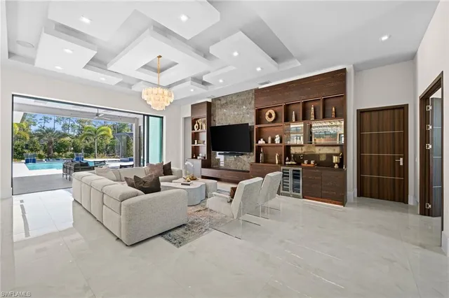 a living room with furniture large window and flat screen tv