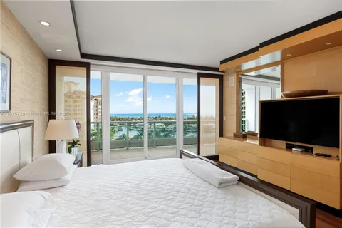 a bedroom with furniture and a flat screen tv