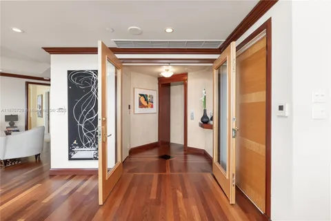 a view of hallway with wooden floor and stairs