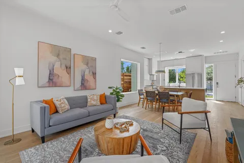 a living room with furniture and wooden floor
