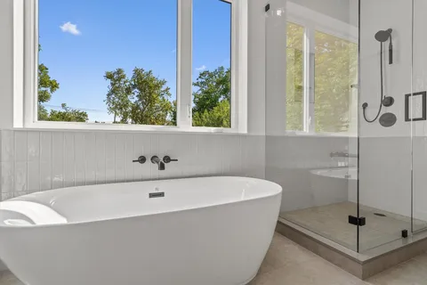 a bathroom with a bathtub and shower