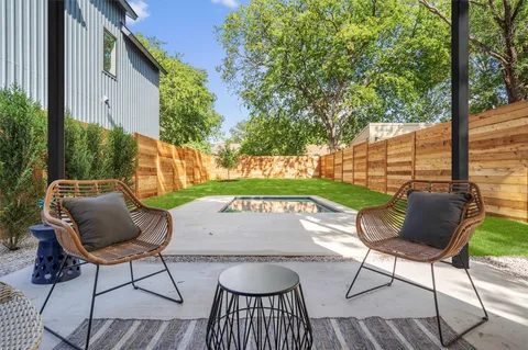a view of patio with table and chairs and potted plants