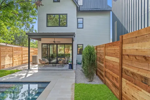 a front view of a house with a large window and a yard