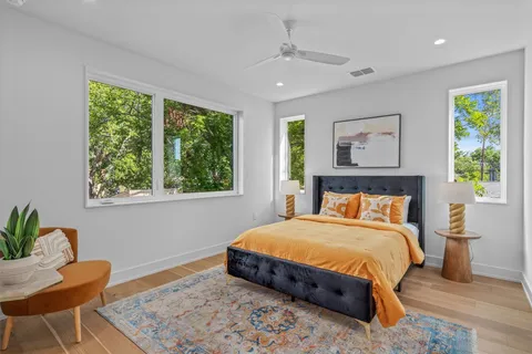 a bedroom with a bed and a chair