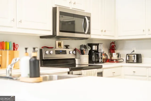 a kitchen with kitchen island granite countertop a sink and cabinets