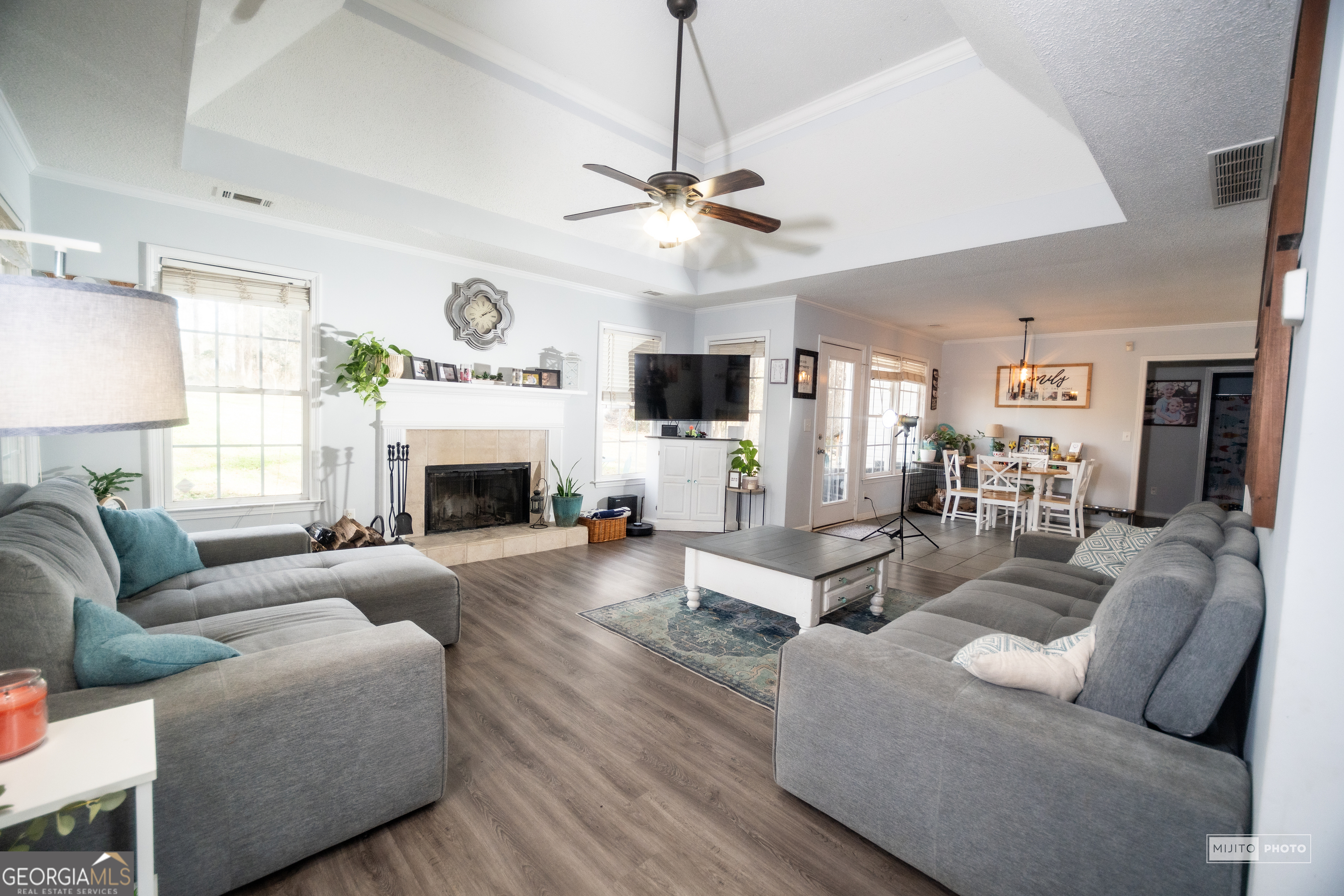 124 Austin Way Jefferson, GA 30549 - Photo 16 of 32 a living room with furniture a fireplace and a ceiling fan