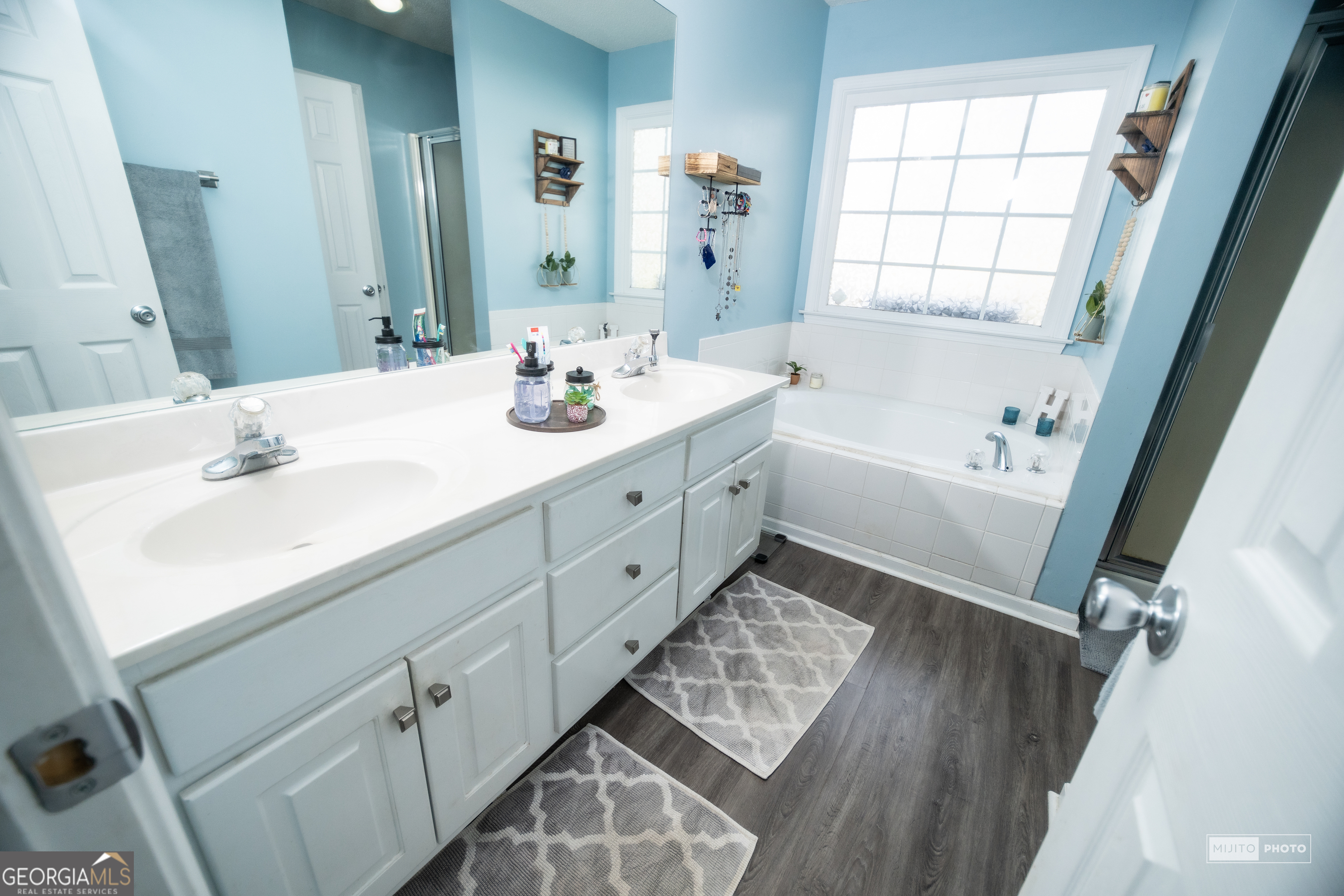 124 Austin Way Jefferson, GA 30549 - Photo 21 of 32 a bathroom with a sink tub vanity and a mirror