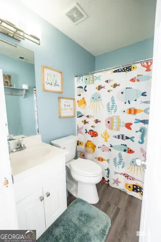 a white toilet sitting next to a bathroom sink