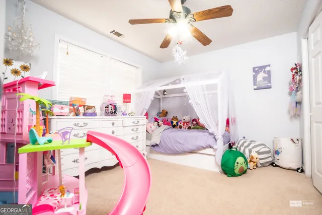 a bedroom with furniture and a baby bed