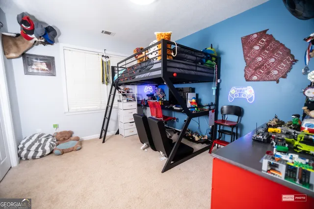 a view of a house with a yard chairs and wooden fence