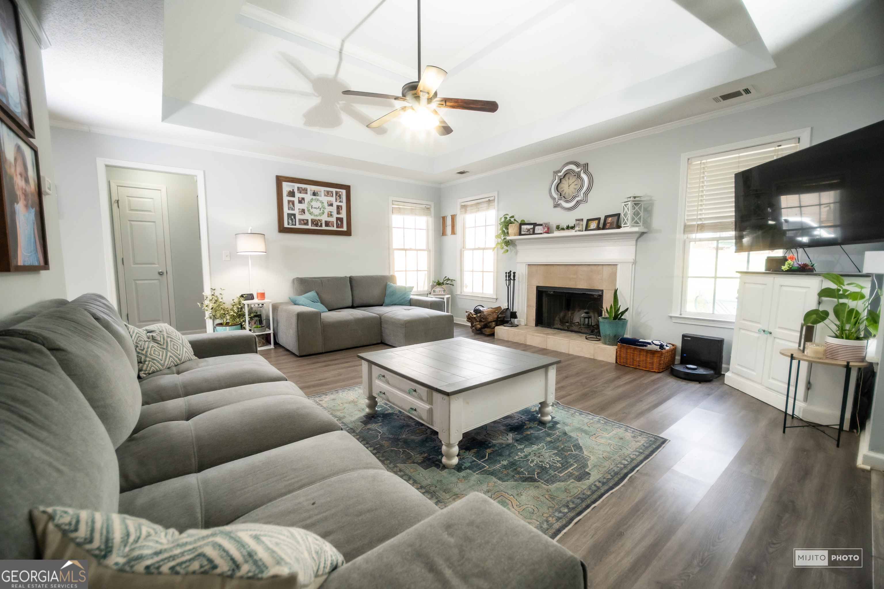 124 Austin Way Jefferson, GA 30549 - Photo 7 of 32 a living room with furniture a fireplace and a flat screen tv