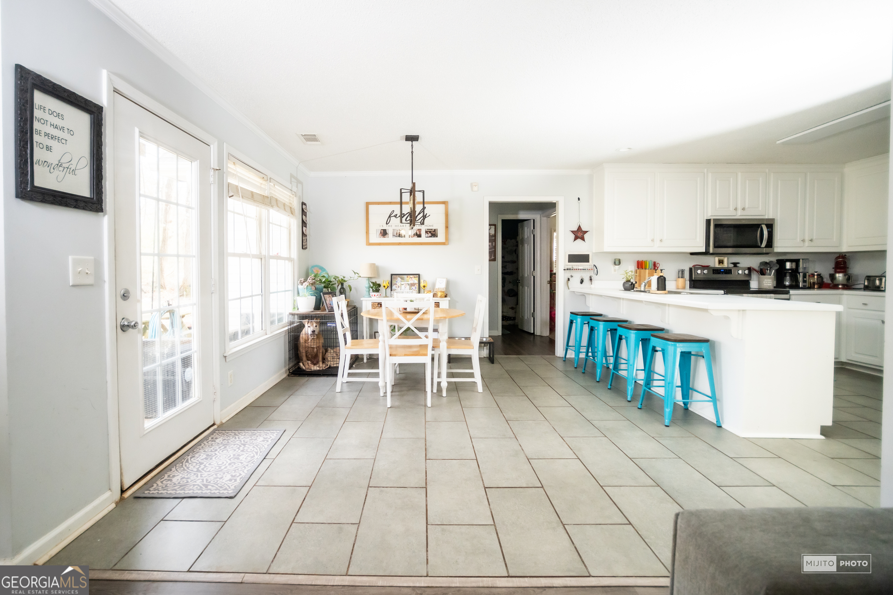124 Austin Way Jefferson, GA 30549 - Photo 8 of 32 a kitchen with stainless steel appliances kitchen island granite countertop a refrigerator and a stove top oven
