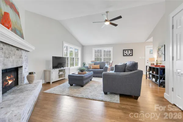 a bedroom with a bed chandelier and a window