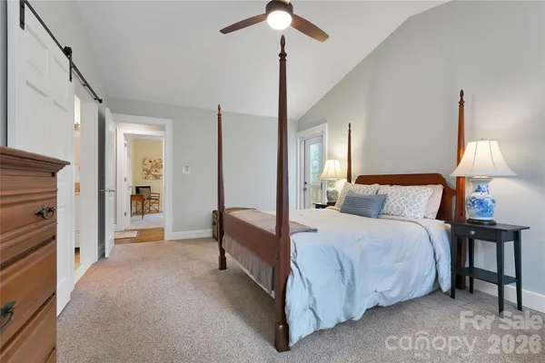 a bedroom with a large bed and a window