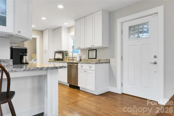 a kitchen with stainless steel appliances granite countertop a sink and a stove