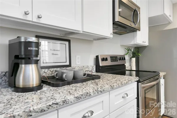 a kitchen with stainless steel appliances granite countertop a refrigerator sink and cabinets
