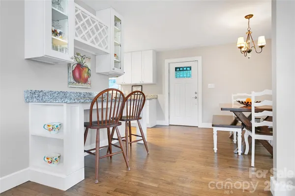 a view of a dining room with furniture and wooden floor