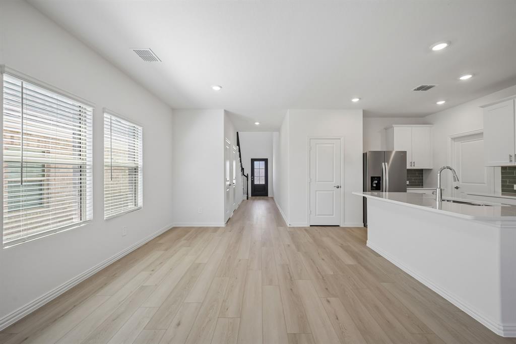1705 Arches Road Anna, TX 75409 - Photo 8 of 33 a view of a big room with wooden floor and windows
