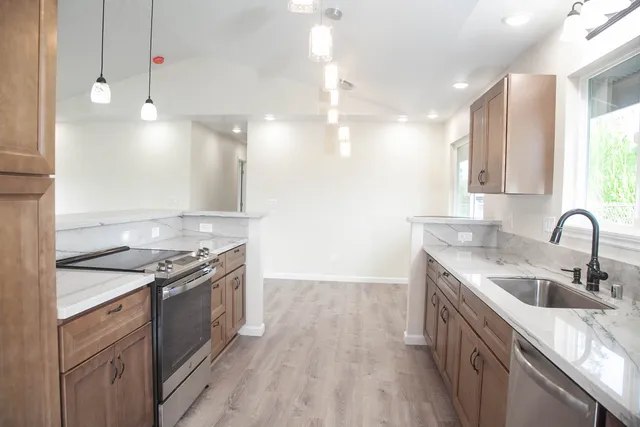 a kitchen with a sink a stove and refrigerator