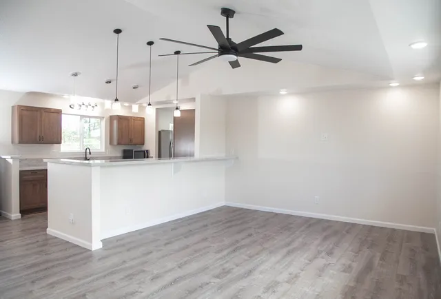 a kitchen with kitchen island white cabinets and stainless steel appliances