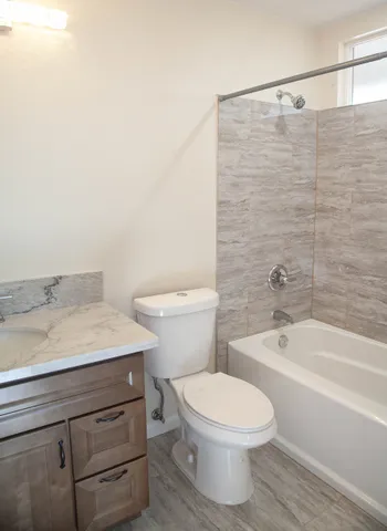 a bathroom with a sink a toilet and bathtub