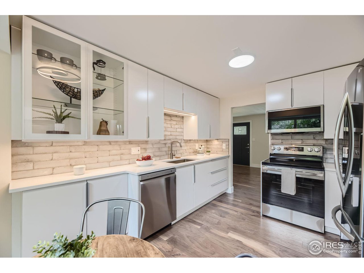 1505 Findlay Way Boulder, CO 80305 - Photo 9 of 31 a kitchen with stainless steel appliances kitchen island granite countertop a sink and cabinets