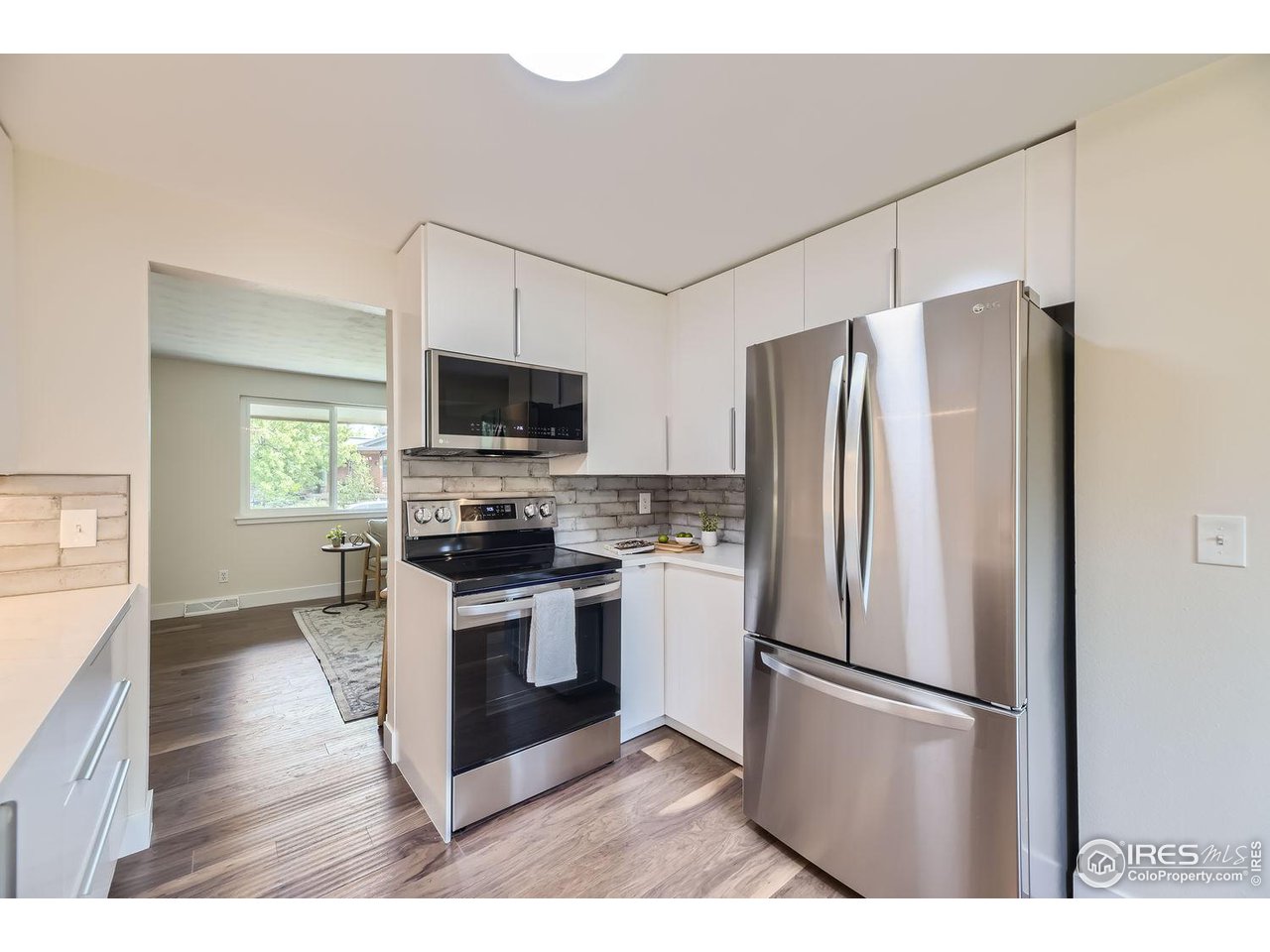 1505 Findlay Way Boulder, CO 80305 - Photo 10 of 31 a kitchen with stainless steel appliances a refrigerator a stove a microwave and cabinets