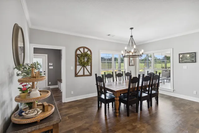 a view of a dining room with furniture wooden floor and chandelier