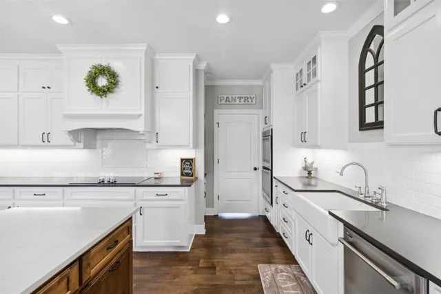 a kitchen with a sink stove and cabinets