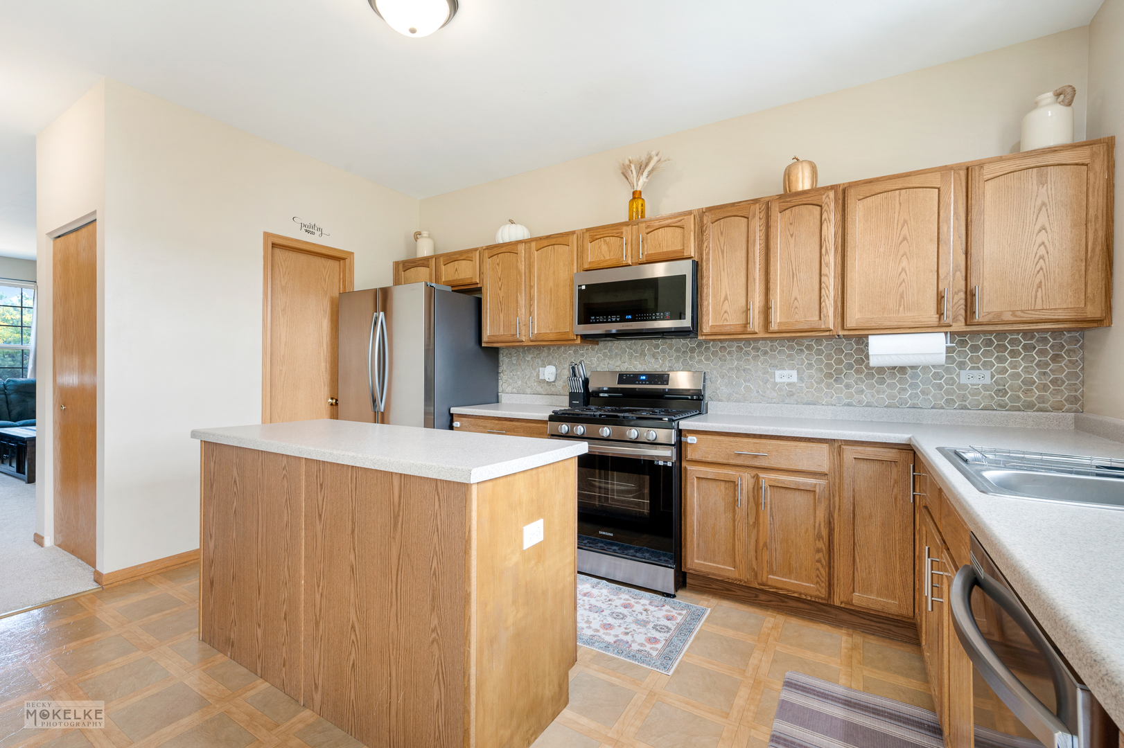 264 South Alder Creek Drive Romeoville, IL 60446 - Photo 3 of 26 a kitchen with stainless steel appliances a stove a sink a microwave and cabinets
