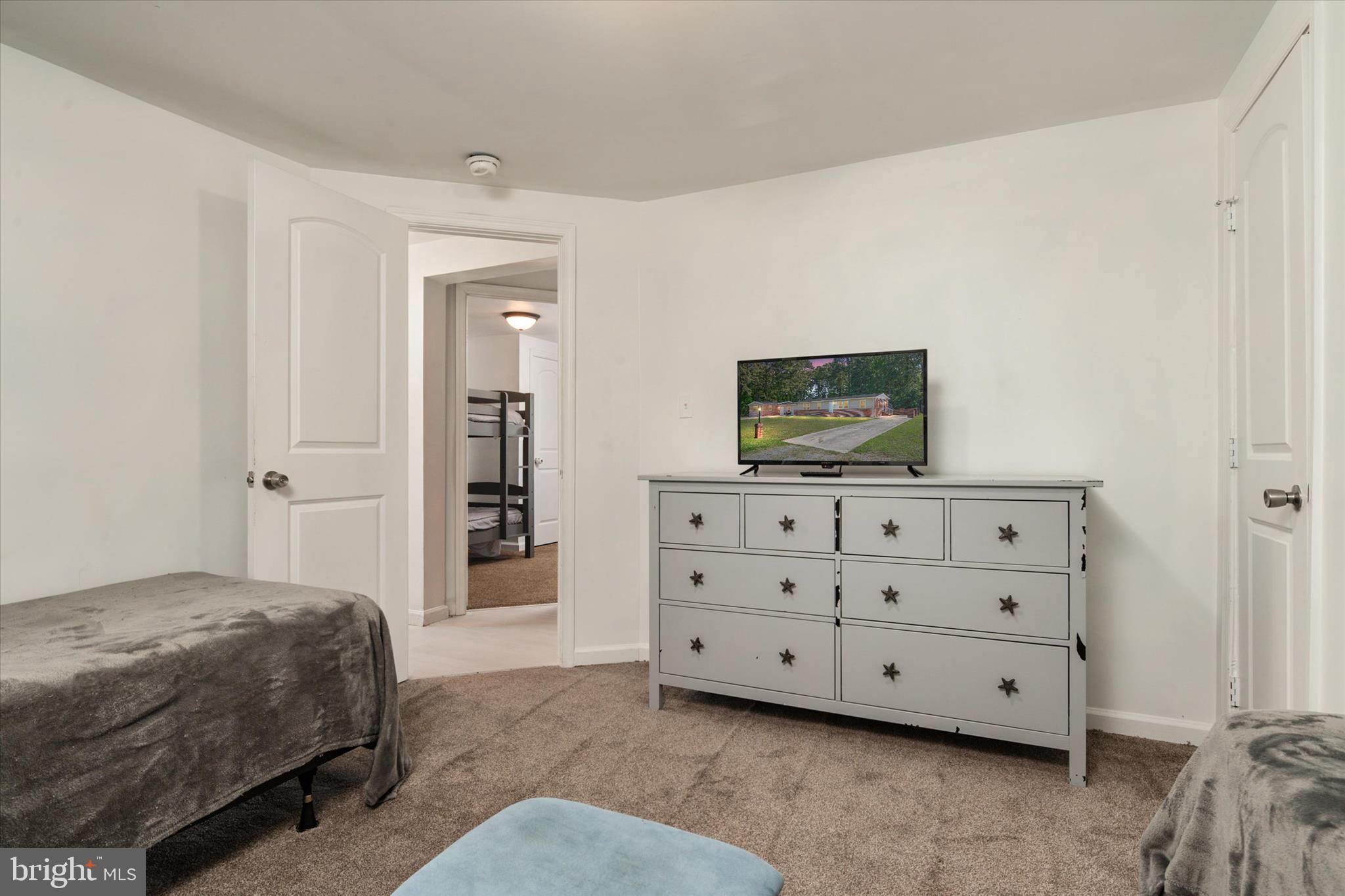108 Wilson Road Grasonville, MD 21658 - Photo 13 of 38 a bedroom with a bed and a television