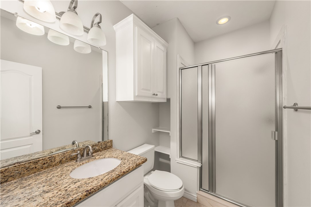 3916 Incourt Lane College Station, TX 77845 - Photo 13 of 15 Full bath featuring a shower stall, toilet, vanity, tile patterned floors, and recessed lighting