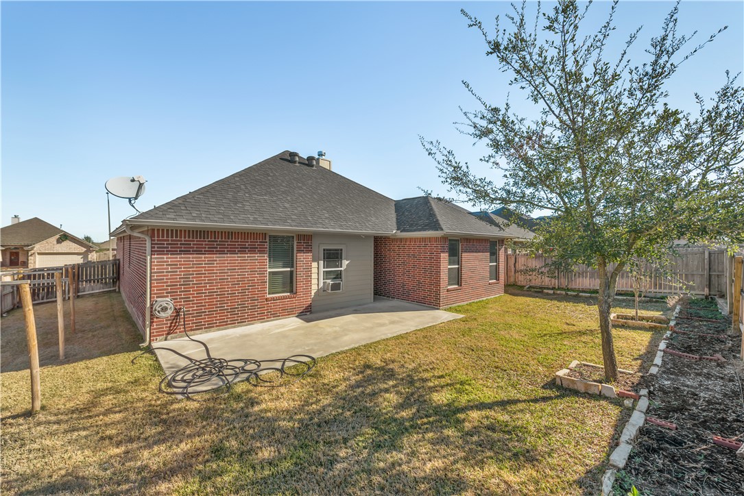 3916 Incourt Lane College Station, TX 77845 - Photo 15 of 15 Back of property with brick siding, a shingled roof, a patio area, and a chimney