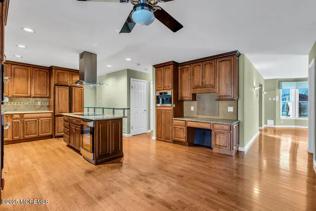 a view of kitchen with granite countertop cabinets and refrigerator