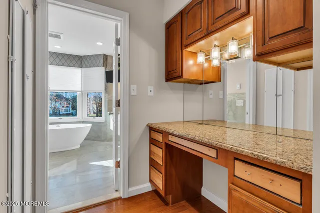 a white bath tub sitting in a bathroom next to a window