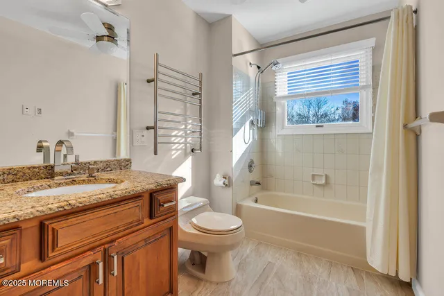 a view of a hallway with wooden floor and entryway