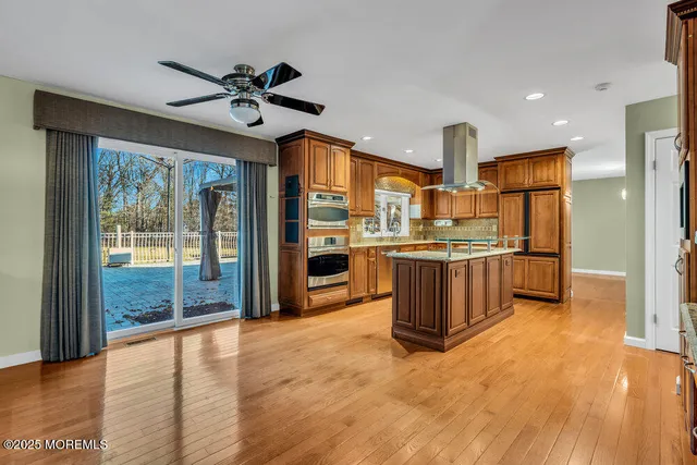 a view of a big room with a big yard and large trees