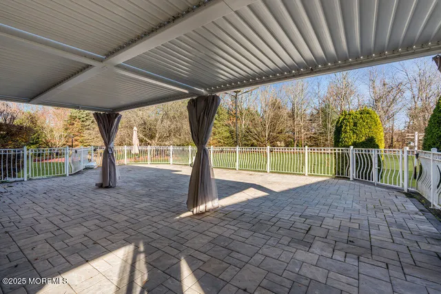 a view of a swimming pool and trees in the background