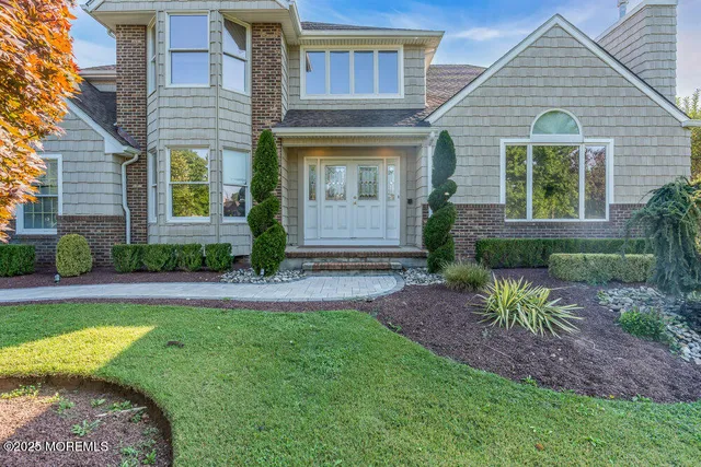 a front view of a house with garden
