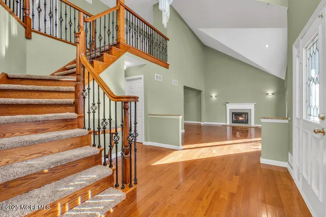 a view of entryway and hall with wooden floor