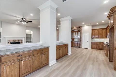 a large kitchen with cabinets a sink and appliances